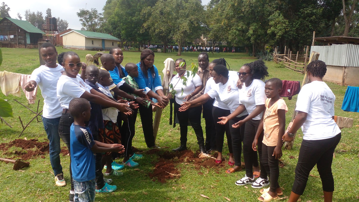 Purpose—Children-holding-a-tree-seedling-with-students-from-Legacy-School
